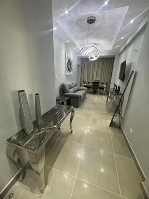 a living room with a couch and a table at Apartamento santo domingo este in Juan López