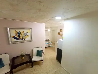 a living room with a couch and a table at Habitacion en el centro in La Julia