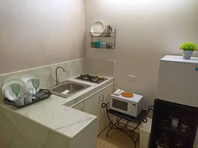 a small kitchen with a sink and a microwave at Habitacion en el centro in La Julia