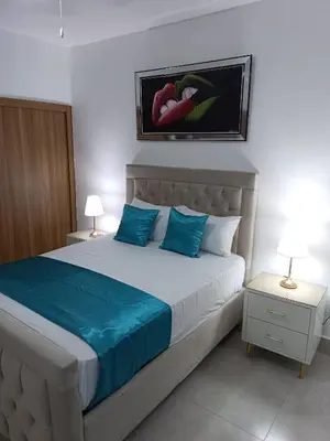 a bedroom with a large bed with blue pillows at Boca del Mar III, apartamento 706A in Boca Chica