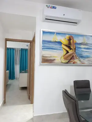 a room with a painting of a woman on the wall at Boca del Mar III, apartamento 706A in Boca Chica