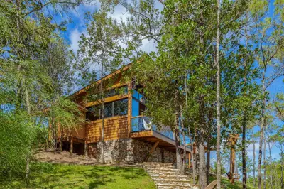 a house built on a rock in the woods at The Grand Forest Jarabacoa in Jarabacoa