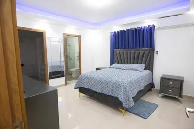 a bedroom with a bed and a television in it at Lujoso y confortable apartamento en Santo Domingo in Santo Domingo