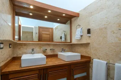a bathroom with two sinks and a large mirror at Aligio Aparthotel, Beachfront, Las Terrenas in Las Terrenas