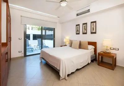 a bedroom with a bed and a sliding glass door at Aligio Aparthotel, Beachfront, Las Terrenas in Las Terrenas