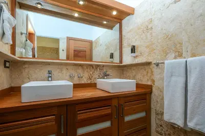 a bathroom with two sinks and a large mirror at Aligio Aparthotel, Beachfront, Las Terrenas in Las Terrenas