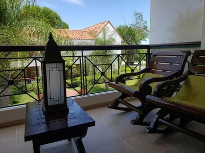 a porch with a bench and a lamp on a balcony at Apartamento Corozos 2-202 in Paraíso
