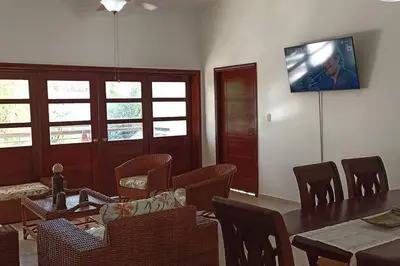 a dining room with a table and chairs and a television at Apartamento Corozos 2-202 in Paraíso
