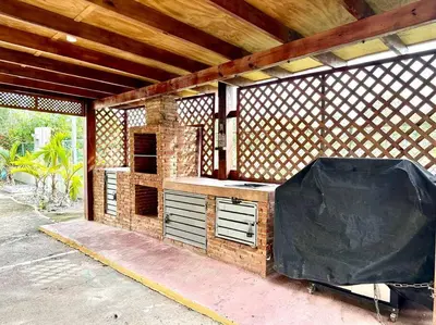 an outdoor kitchen with a black tarp on it at Luperon candles apartment in Puerto de Luperon