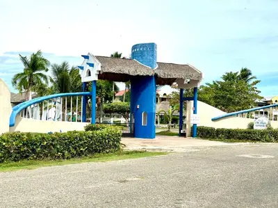 a blue and white gas station with a roof at Luperon candles apartment in Puerto de Luperon