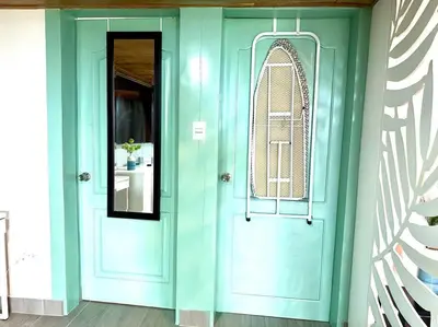 a blue door in a room with a mirror at Luperon candles apartment in Puerto de Luperon