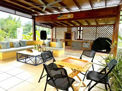 a patio with chairs and a table and a couch at Luperon candles apartment in Puerto de Luperon