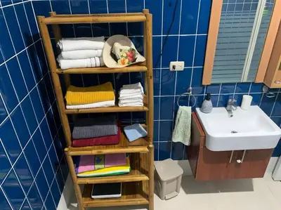 a bathroom with a towel rack next to a sink at Villa en boca chica in Cuevas