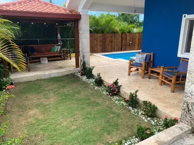 a patio with two chairs and a swimming pool at Villa en boca chica in Cuevas