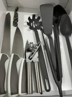 a bunch of kitchen utensils in a drawer at Cozy Apartment in the heart of Santiago in Santiago de los Caballeros