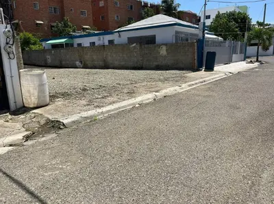 an empty street next to a fence and a building at Cozy Apartment in the heart of Santiago in Santiago de los Caballeros