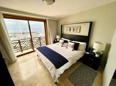 a bedroom with a large bed and a large window at Hotel en Samana con vista al Mar in Sabana