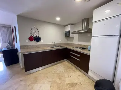 a kitchen with a sink and a white refrigerator at Hotel en Samana con vista al Mar in Sabana