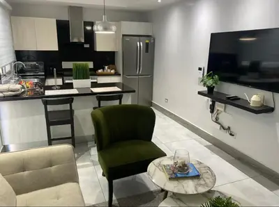 a kitchen with a chair and a table in a room at PiantiniTowerCentric SDQ CityView in Santo Domingo