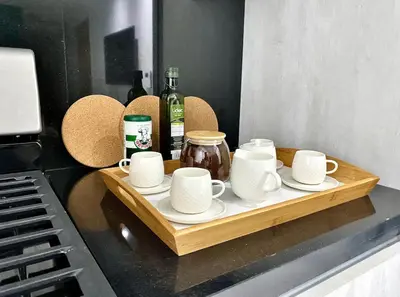 a tray with cups and saucers on a counter next to a keyboard at PiantiniTowerCentric SDQ CityView in Santo Domingo