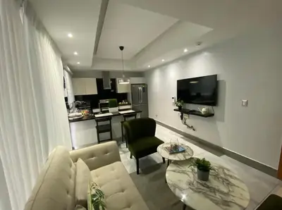 a living room with a couch and a table at PiantiniTowerCentric SDQ CityView in Santo Domingo