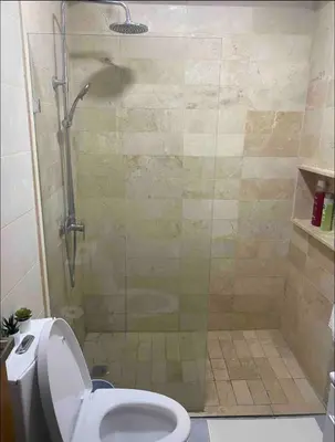 a bathroom with a shower and a toilet at PiantiniTowerCentric SDQ CityView in Santo Domingo