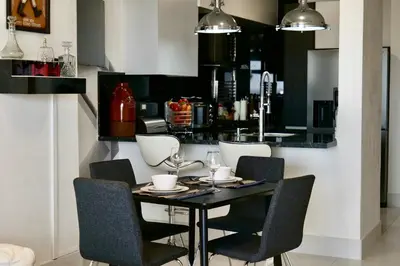 a dining room with a black table and chairs at Arpel 6 SantoDomingo CItySeaView in Santo Domingo