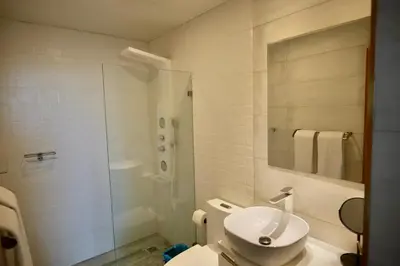 a bathroom with a toilet and a shower and a sink at Arpel 6 SantoDomingo CItySeaView in Santo Domingo