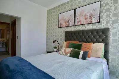 a bedroom with a large bed with pillows on it at Arpel 6 SantoDomingo CItySeaView in Santo Domingo