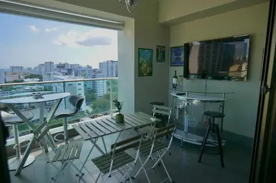 a room with a balcony with a table and chairs at Arpel 6 SantoDomingo CItySeaView in Santo Domingo