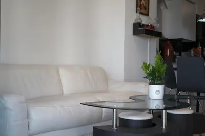 a living room with a white couch and a table at Arpel 6 SantoDomingo CItySeaView in Santo Domingo