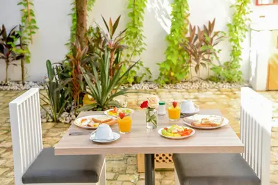 a wooden table with plates of food and drinks on it at Honky Tonk Colonial in Santo Domingo