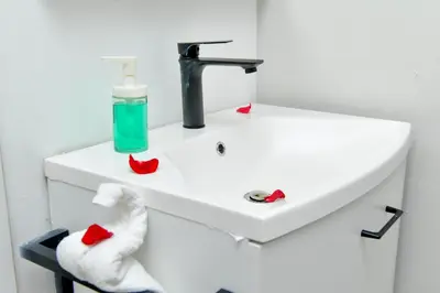 a bathroom with a sink with a towel at Honky Tonk Colonial in Santo Domingo