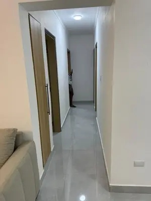 a hallway with a person standing in the distance at RESIDENCIAL LEGADO Apto 1 A in Azua