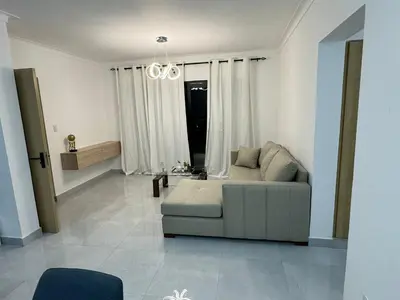 a living room with a couch and a chandelier at RESIDENCIAL LEGADO Apto 1 A in Azua