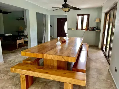 a wooden table and bench in a living room at Exclusive Mountain Villa with Ocean View near Puerto Plata in Maimón