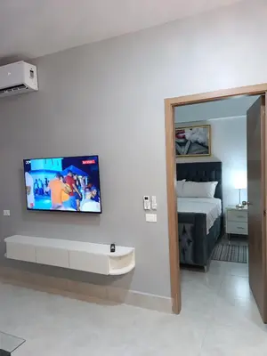 a room with a bed and a tv on a wall at Boca del Mar III, apto 707 in Boca Chica