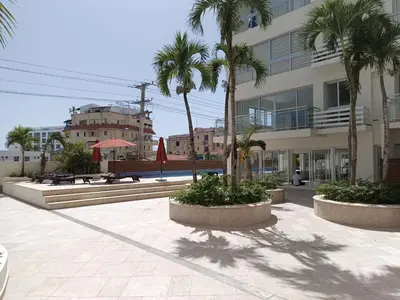 a courtyard with palm trees in front of a building at Boca del Mar III, apto 707 in Boca Chica