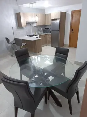 a glass table and chairs in a kitchen at Boca del Mar III, apto 706B in Boca Chica