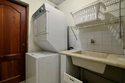 a kitchen with a sink and a washer and dryer at Comfortable Apt Laura Virginia in Santo Domingo in Santo Domingo