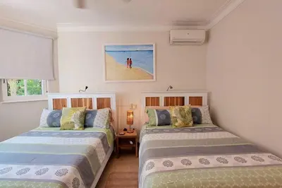 a bedroom with two beds and a picture of a beach at Playa Las Ballenas Oceanfront in Las Terrenas