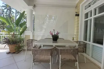 a white table and chairs on a porch at Playa Las Ballenas Oceanfront in Las Terrenas
