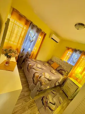 a small bedroom with a bed and a table at Acogedor apartamento in Azua de Compostela