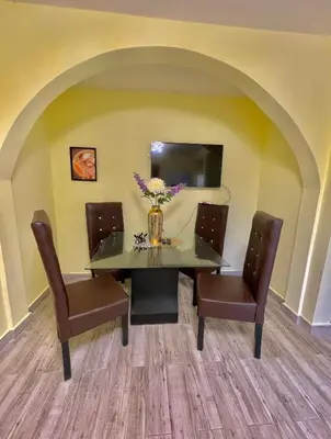 a dining room with a table and two chairs at Acogedor apartamento in Azua de Compostela