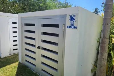 a white garage door with a baja sign on it at 1st Line view in San Pedro de Macorís
