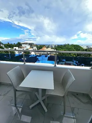 a table and chairs on a balcony with a view at Hotel Gutz in San Felipe de Puerto Plata