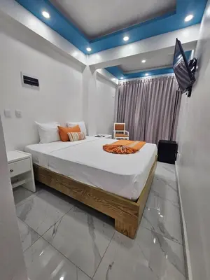 a bedroom with a large bed in a room at Hotel Gutz in San Felipe de Puerto Plata