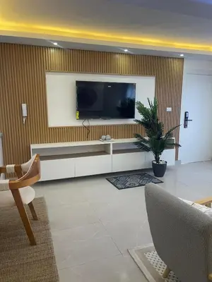 a living room with a flat screen tv on a wall at Hermoso apto amueblado a 5 minutos de downtown Punta Cana in Punta Cana