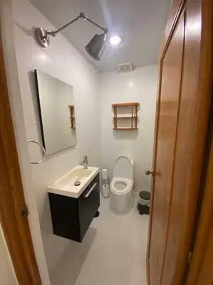 a bathroom with a sink and a toilet and a mirror at Apartment with ocean front view in Juan Dolio