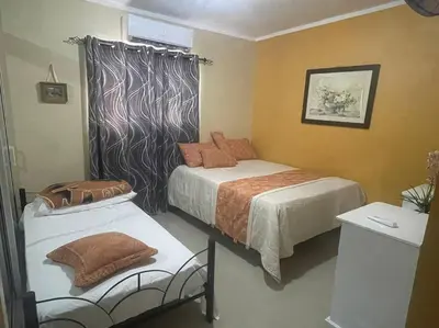 a bedroom with two beds and a window and a bedskirts at Sábana de la mar in La Tentación